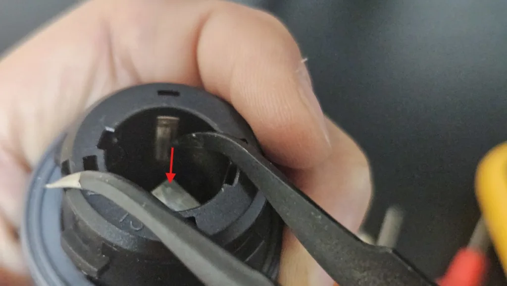 깜박이 소켓 단자를 핀셋으로 바깥쪽으로 휘어 탄성을 회복시키는 모습